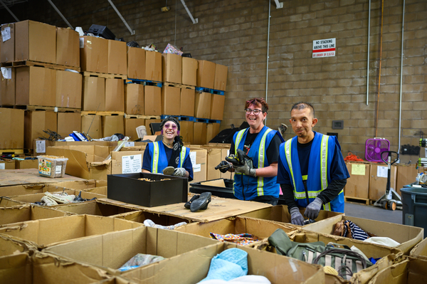 Three people in a wearhouse